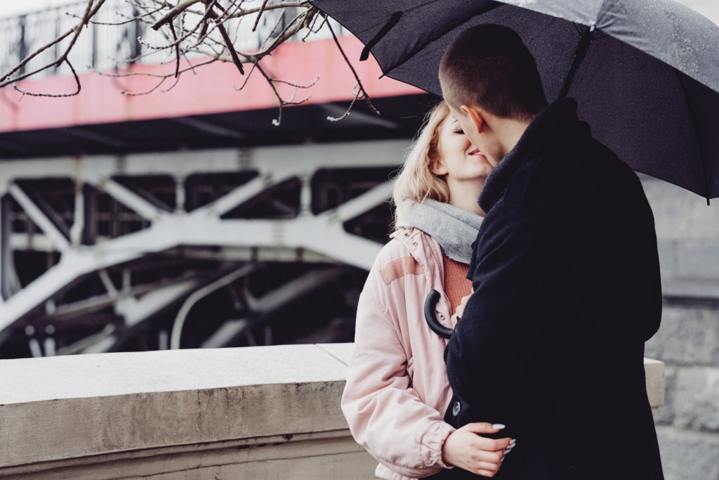 A couple kissing under an umbrella 3 - free stock photo