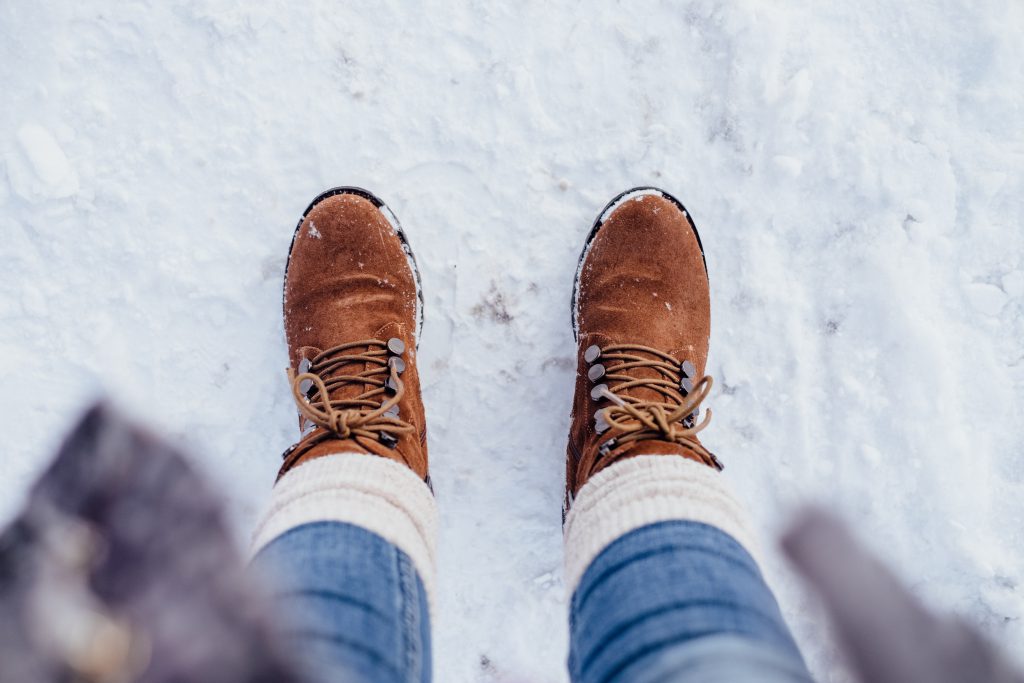 female_feet_standing_on_a_snow_covered_pavement-1024x683.jpg