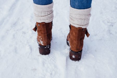 Female feet standing on a snow-covered pavement 3 - free stock photo