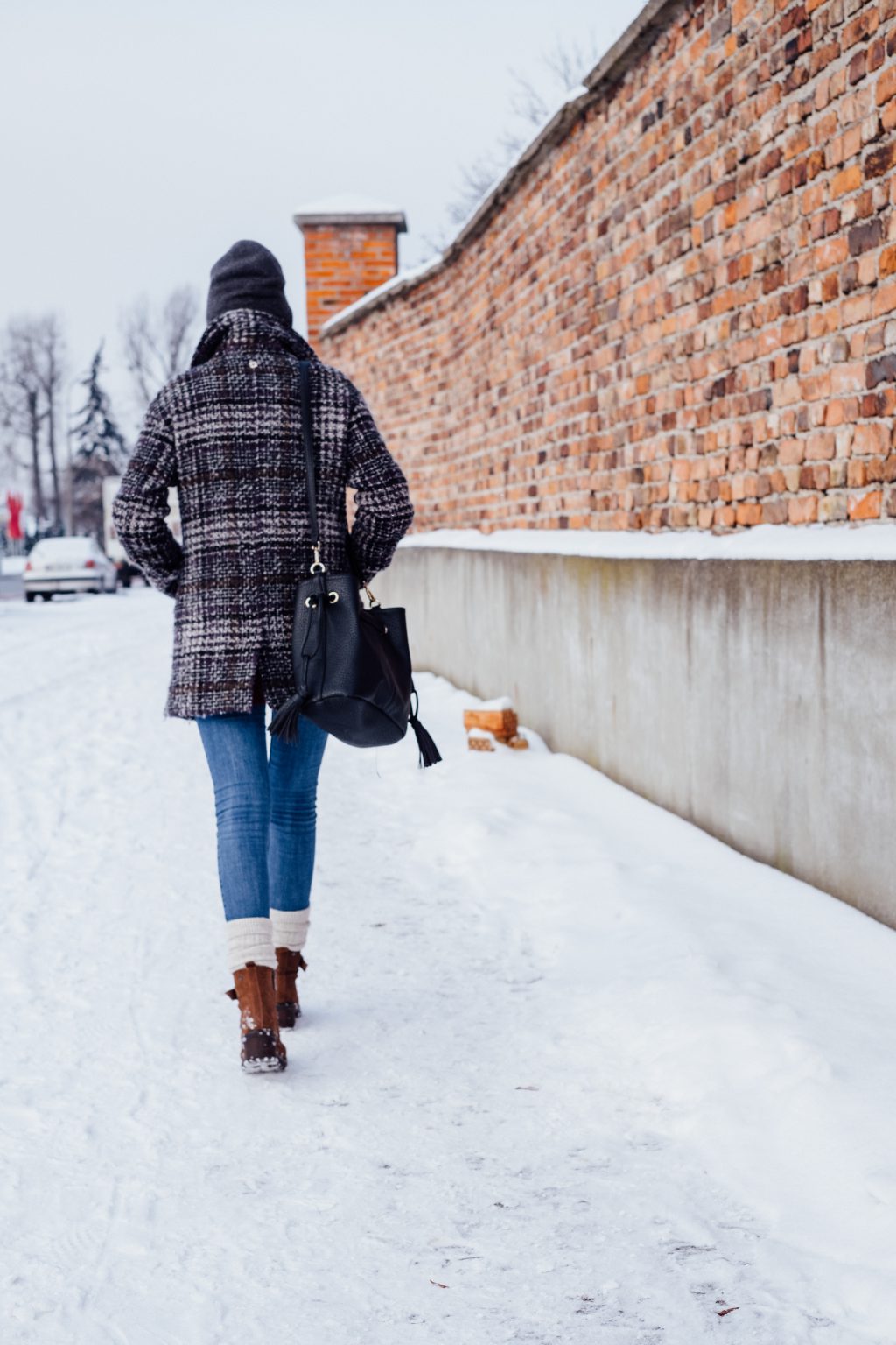 female_walking_on_a_snow_covered_pavemen