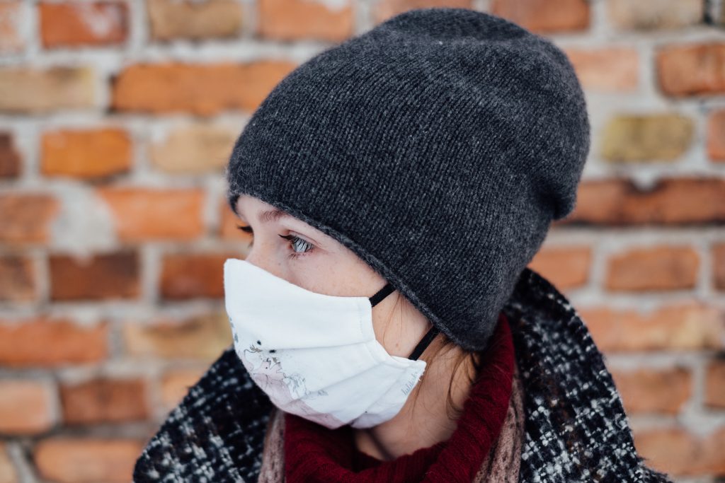 A female wearing a protective face mask closeup - free stock photo