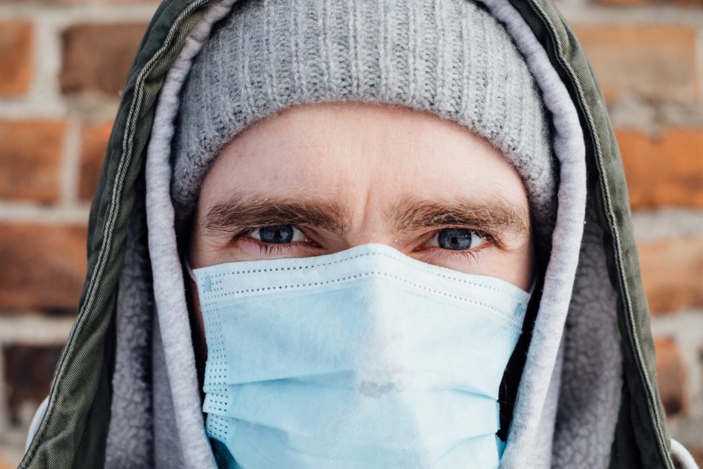 A male wearing a protective face mask closeup 2 - free stock photo