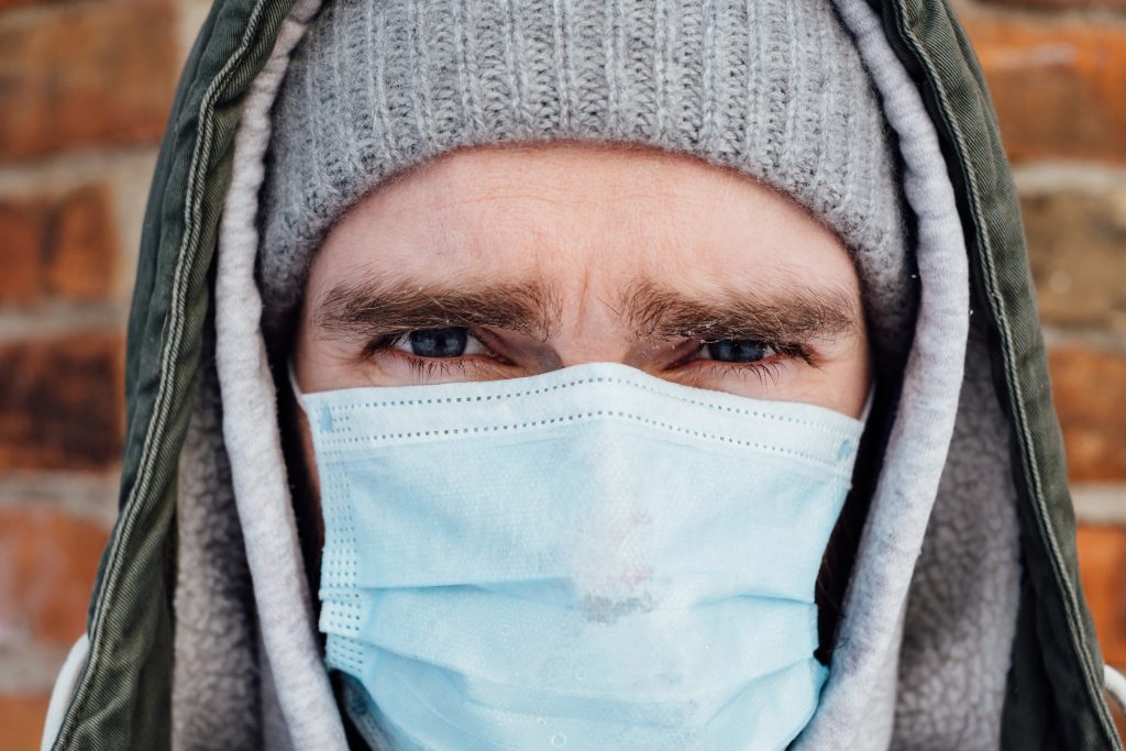 A male wearing a protective face mask closeup 3 - free stock photo
