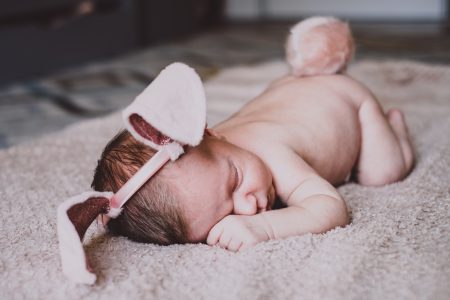 Newborn baby with bunny ears and a tail - free stock photo
