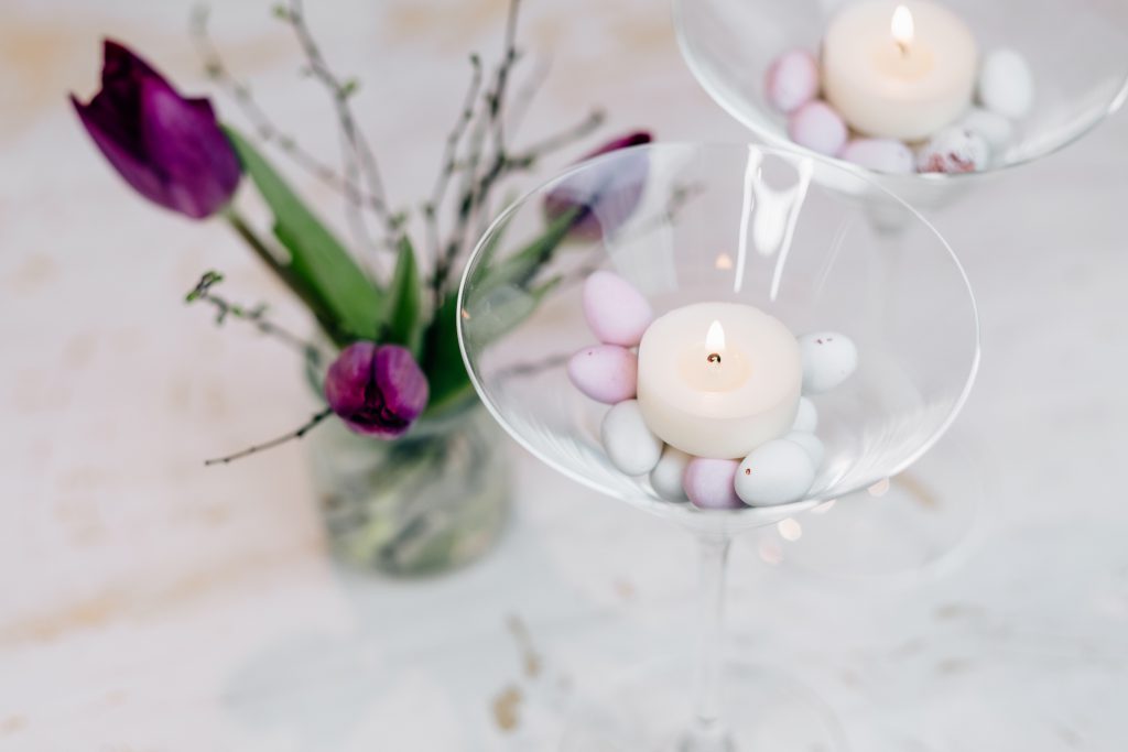 Table candle decoration with purple tulips - free stock photo