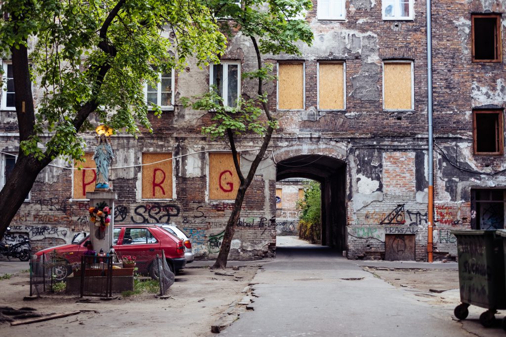 Catholic holy figure worship place outside a poor neighbourhood building - free stock photo