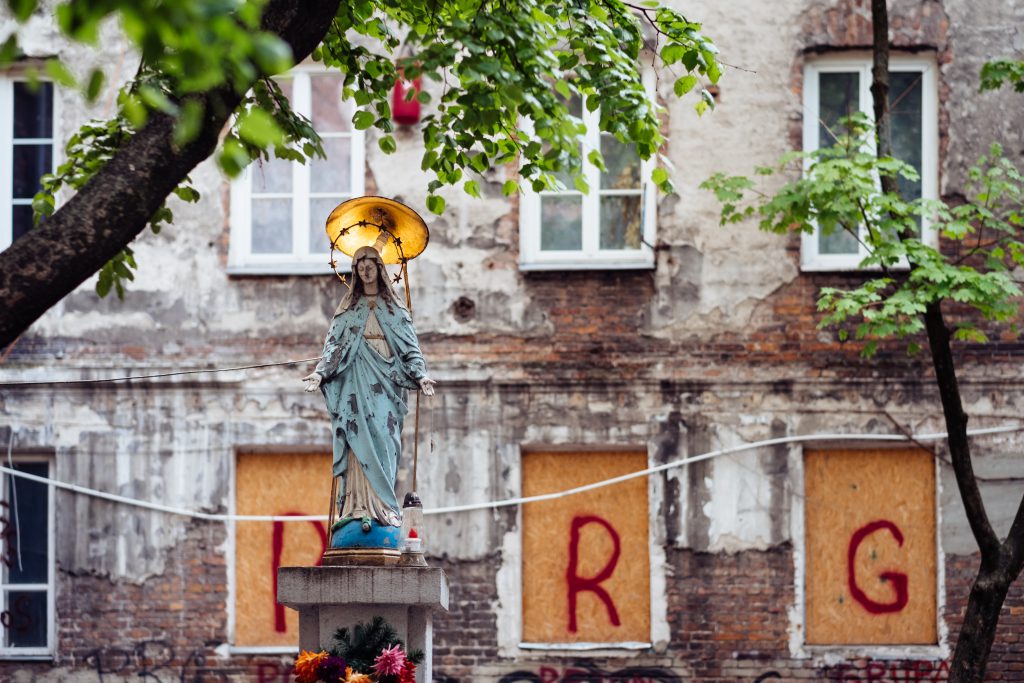 Catholic holy figure worship place outside a poor neighbourhood building 2 - free stock photo