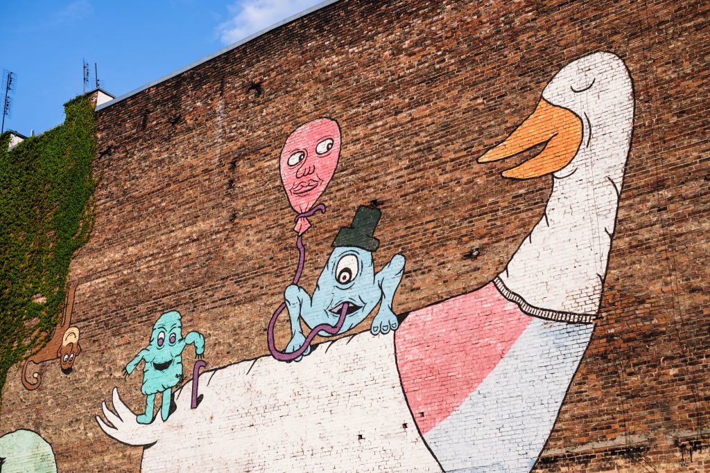 Graffiti of a cartoon duck on a brick wall - free stock photo