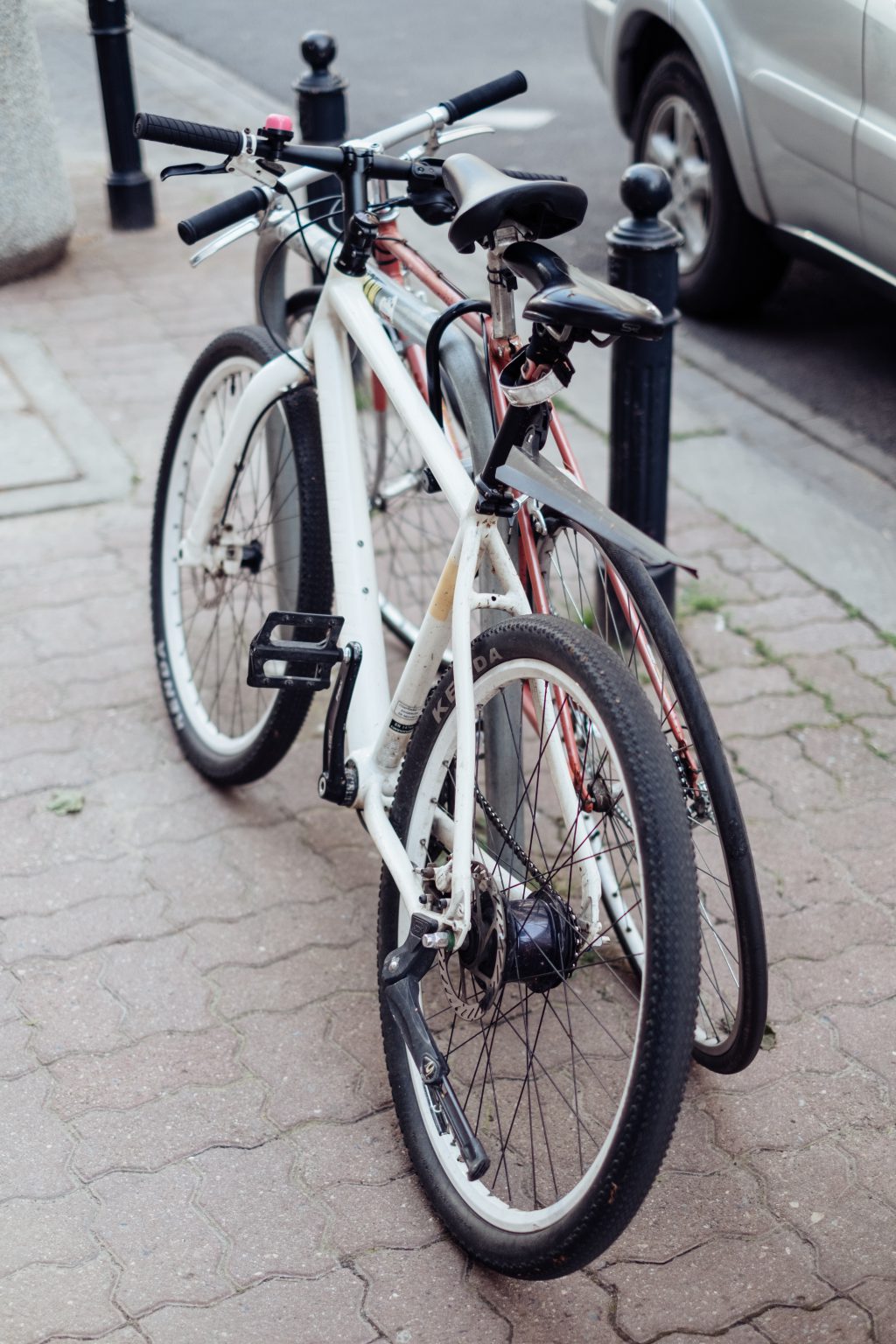 Bicycles attached to a bike rack - free stock photo