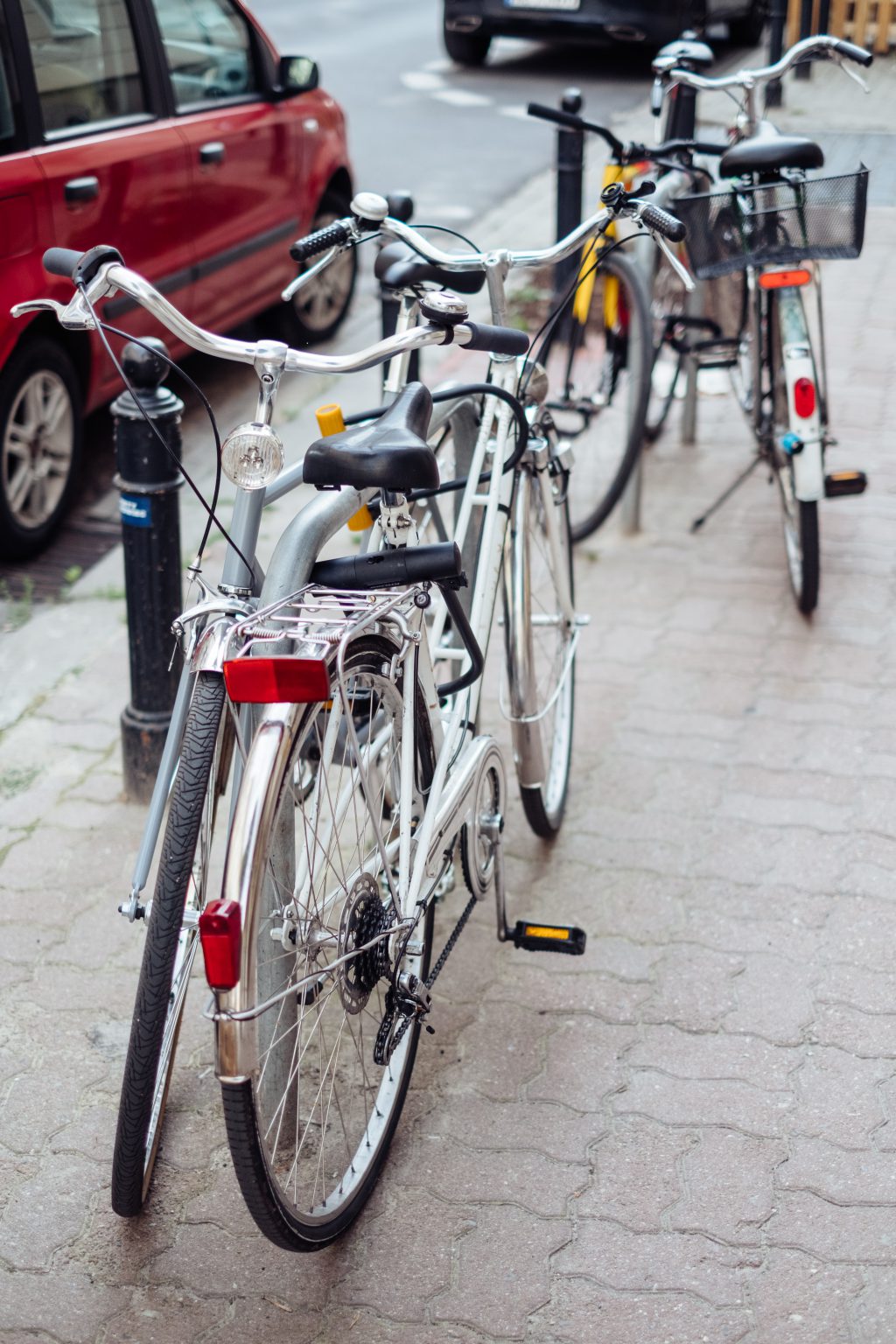 Bicycles attached to bike racks - free stock photo