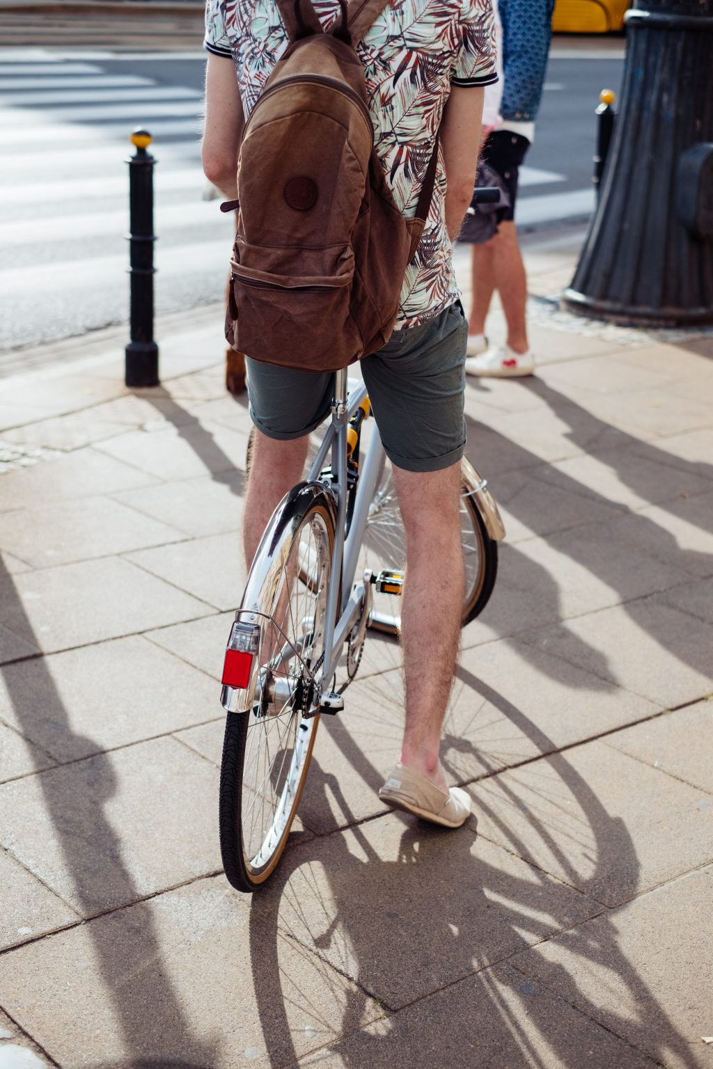 Cyclist and a pedestrian waiting at the road zebra crossing - free stock photo