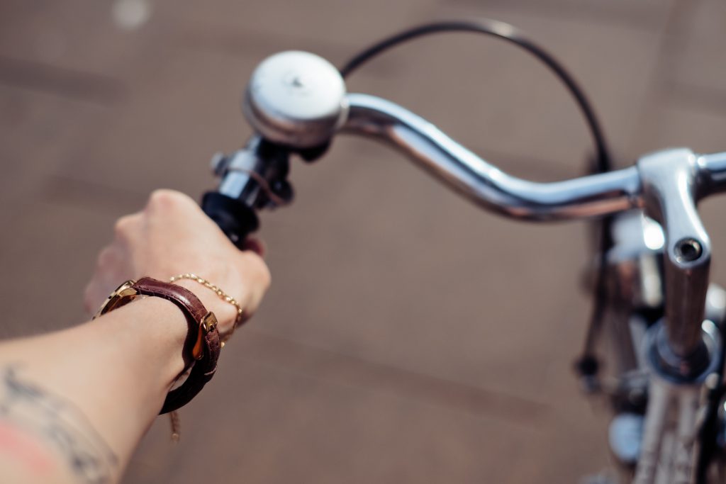 Female hand holding a bicycle handlebar - free stock photo