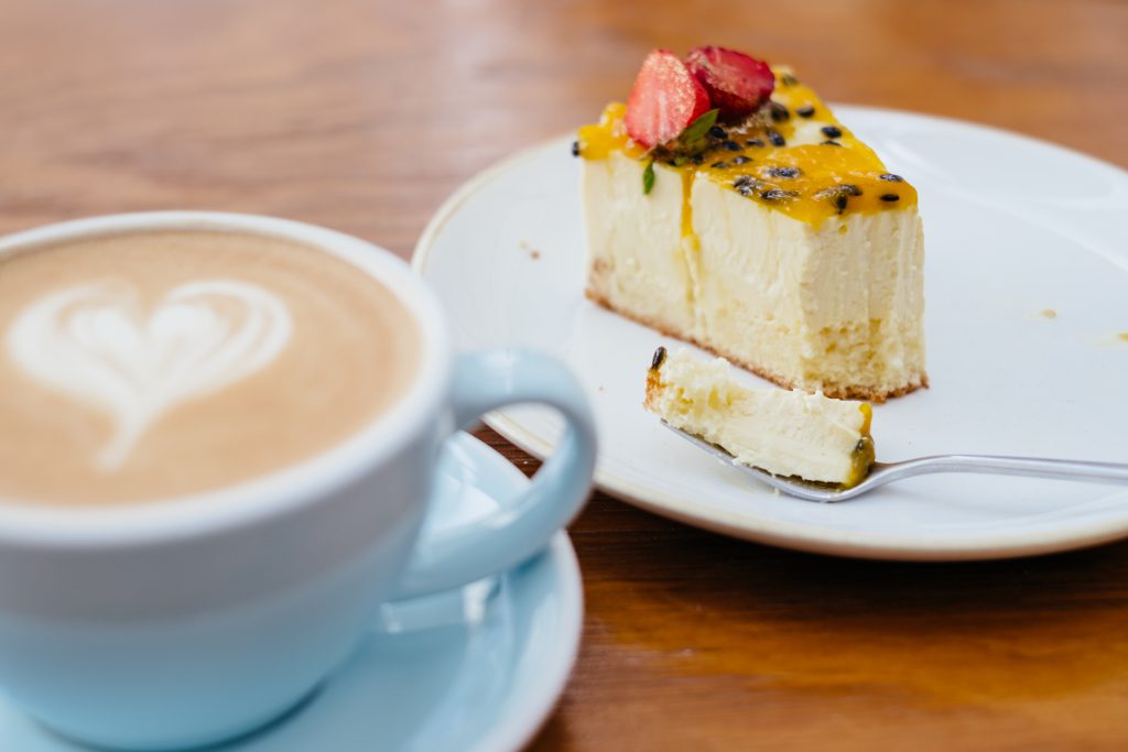 Latte and a cheesecake on a café table 2 - free stock photo