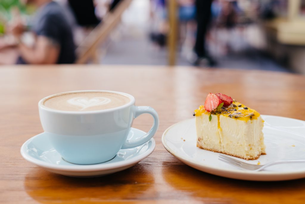 Latte and a cheesecake on a café table 3 - free stock photo