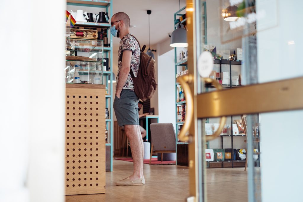 Male customer waiting at the counter in a café - free stock photo