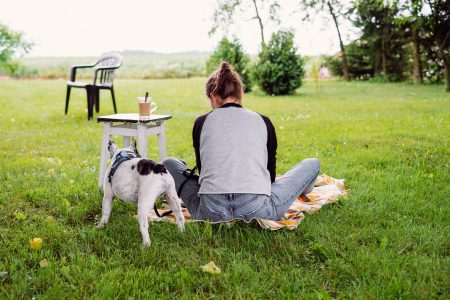 Female having a coffee outdoors with a frenchie - free stock photo