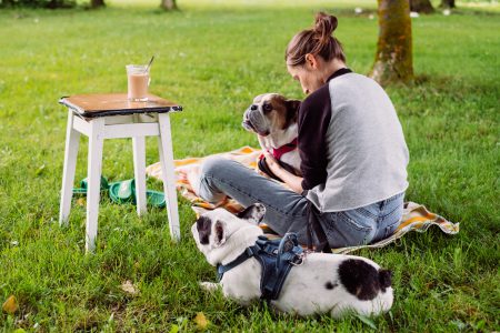 Female having a coffee outdoors with dogs - free stock photo