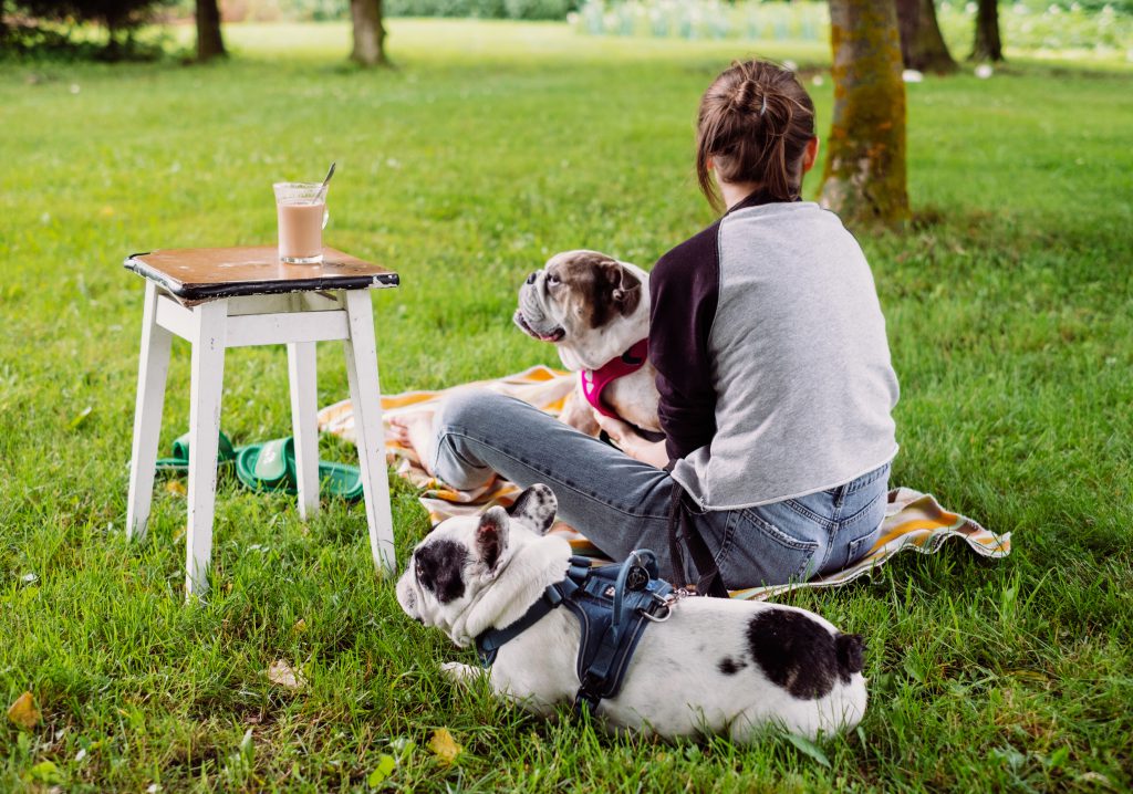 Female having a coffee outdoors with dogs 2 - free stock photo