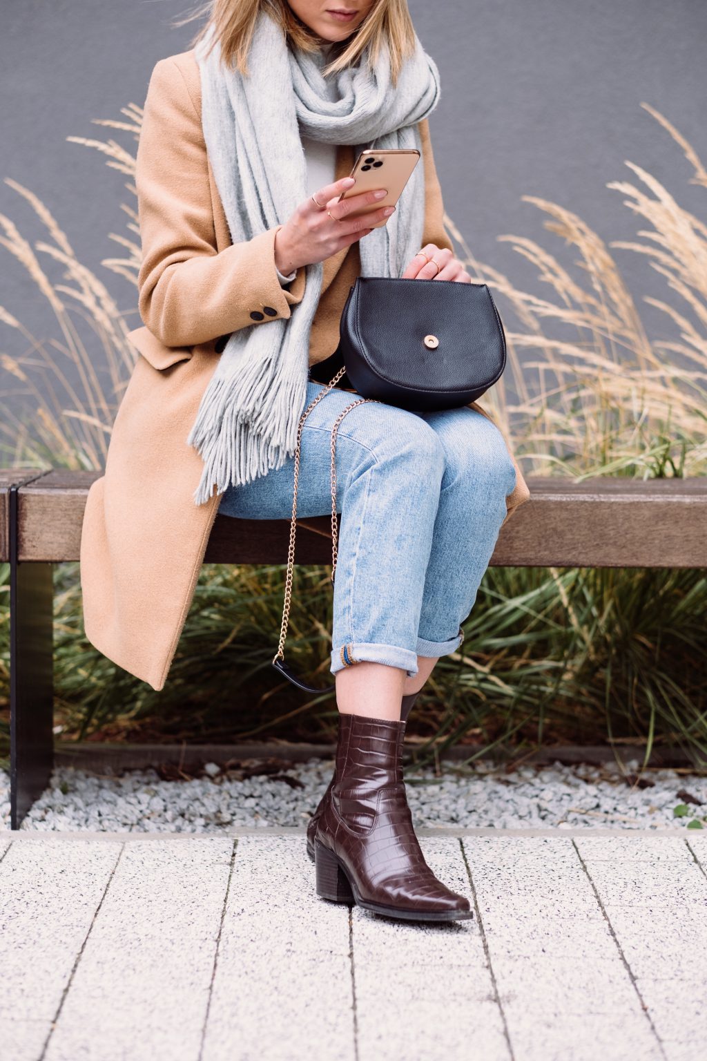 Female holding her phone and purse on an autumn day 2 - free stock photo