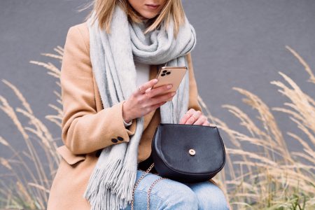 Female holding her phone and purse on an autumn day 2 - free stock photo