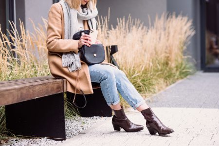 Female looking for something in her purse on an autumn day - free stock photo