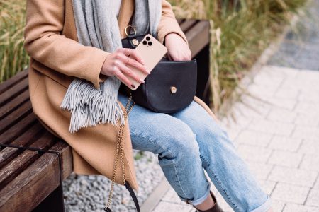 Female looking for something in her purse on an autumn day 2 - free stock photo