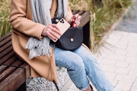 Female taking out the keys from her purse on an autumn day - free stock photo
