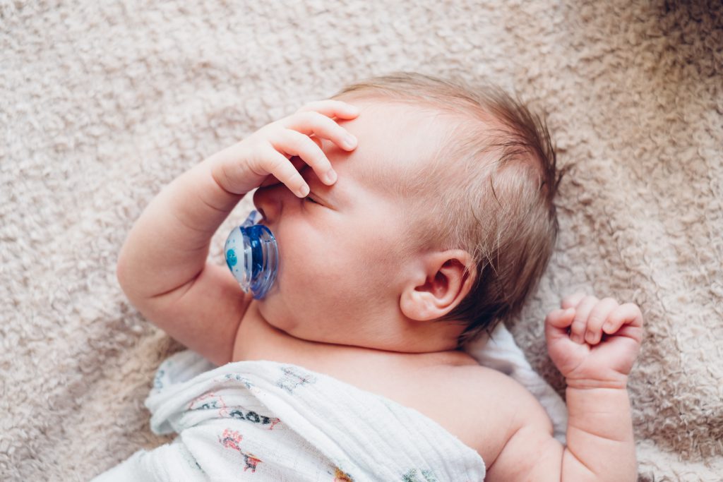Newborn baby facepalm - free stock photo