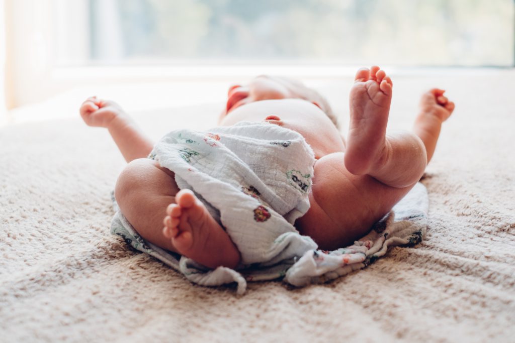 Newborn baby lying down on the mattress 2 - free stock photo