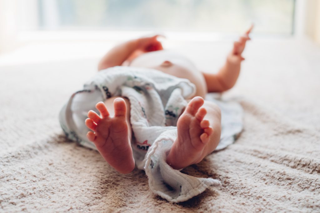 Newborn baby lying down on the mattress 3 - free stock photo