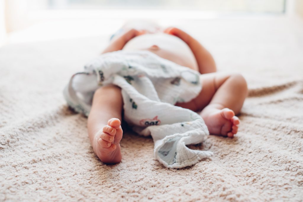 Newborn baby lying down on the mattress 4 - free stock photo