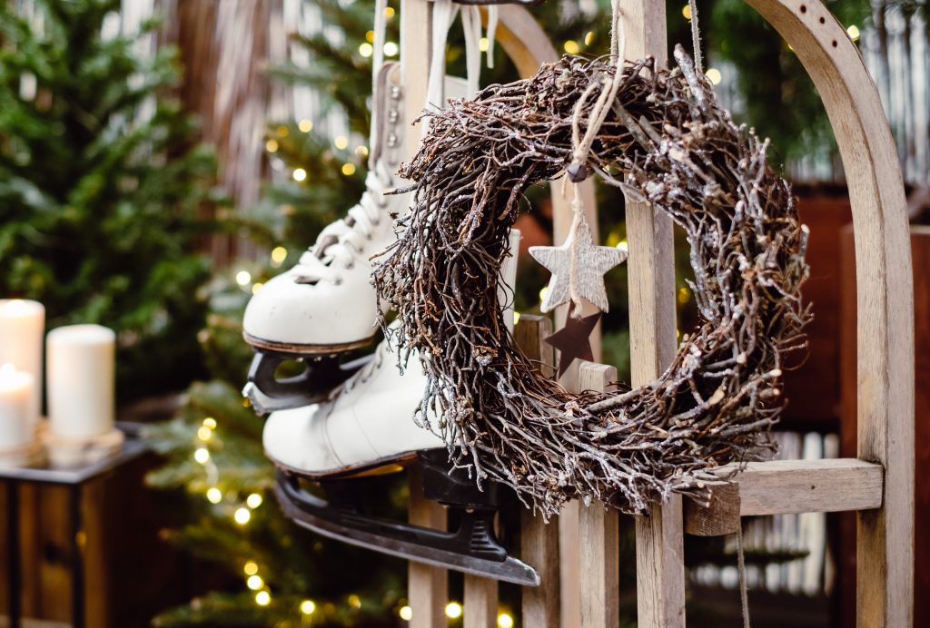 Christmas wreath and vintage ice skates on a wooden sled - free stock photo