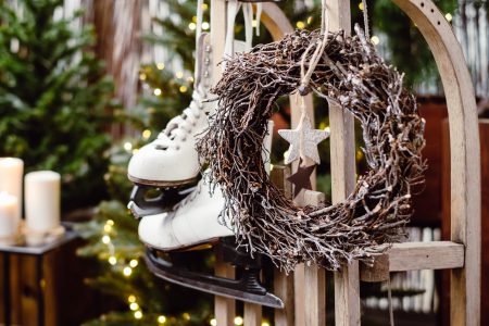 Christmas wreath and vintage ice skates on a wooden sled - free stock photo