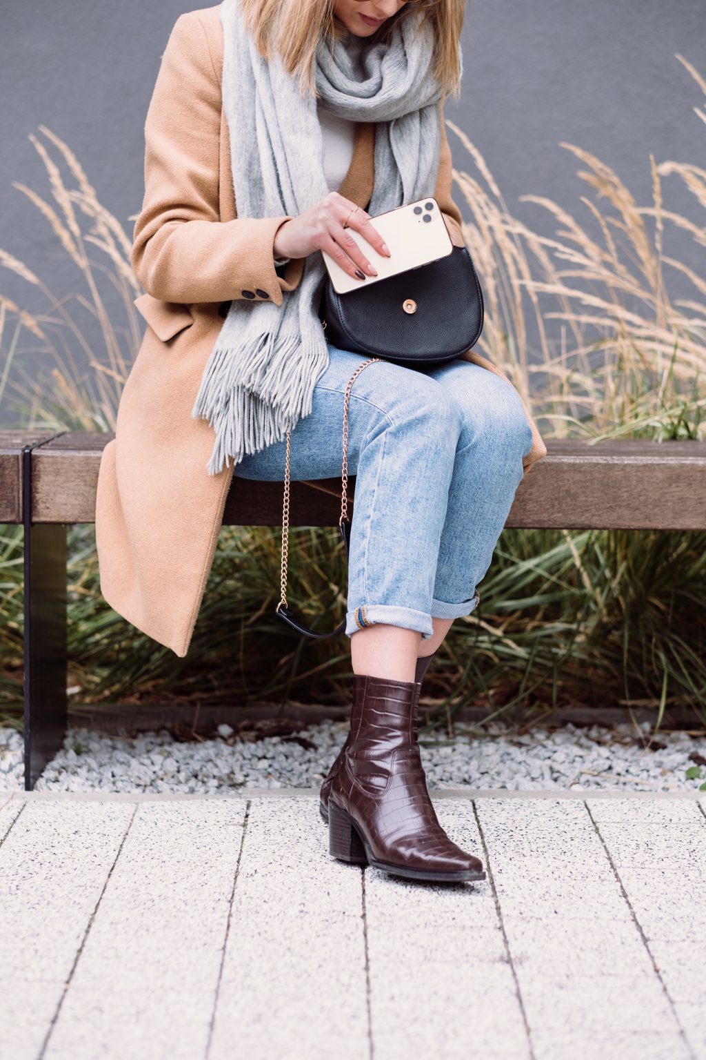 A female looking for something in her purse on an autumn day 3 - free stock photo