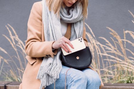 A female looking for something in her purse on an autumn day 3 - free stock photo