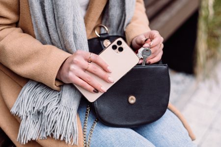 A female taking out the keys from her purse on an autumn day 2 - free stock photo