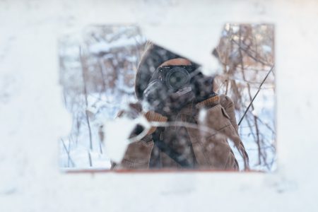 Broken mirror reflection of a female taking a photo on a winter day - free stock photo