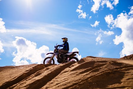 Motor biker on a hill at a sand quarry - free stock photo