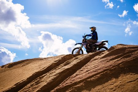 Motor biker on a hill at a sand quarry 2 - free stock photo