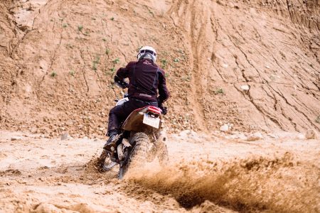 Motor biker riding through a sand quarry 2 - free stock photo