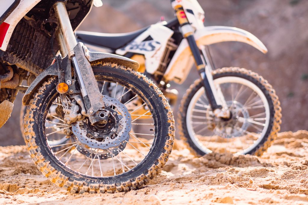 Two motorbikes at a sand quarry details - free stock photo