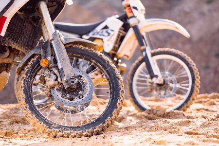 Two motorbikes at a sand quarry details - free stock photo