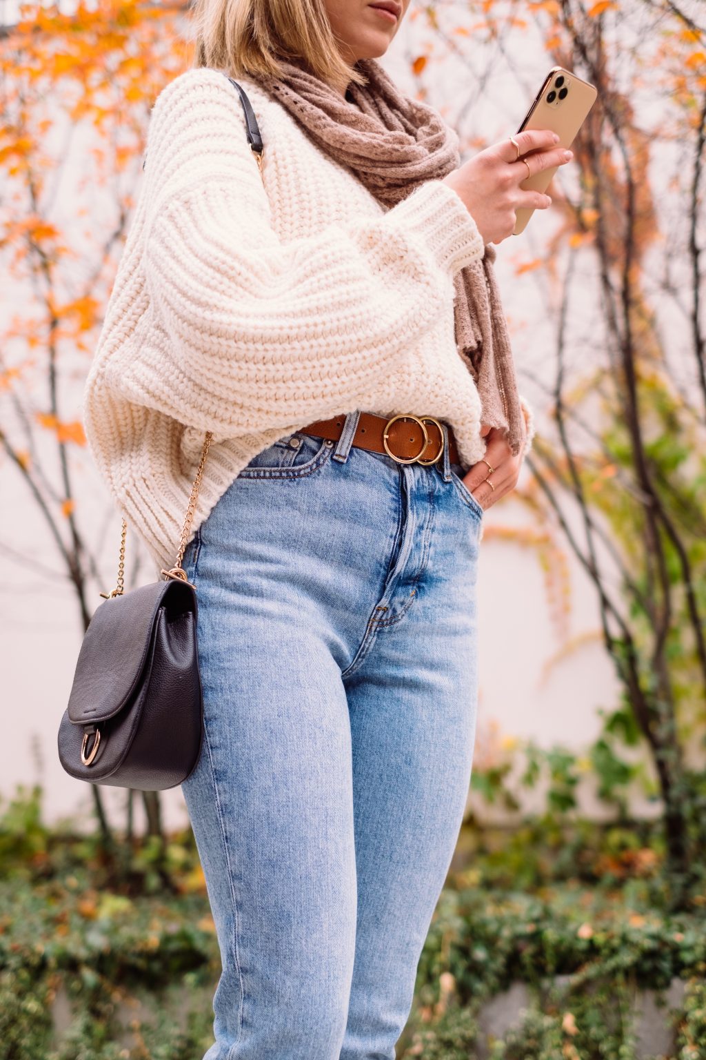 Female holding her phone on an autumn day 2 - free stock photo