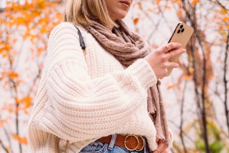 Female holding her phone on an autumn day 2 - free stock photo