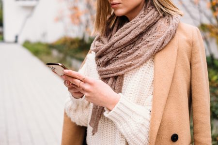 Female holding her phone on an autumn day closeup 2 - free stock photo