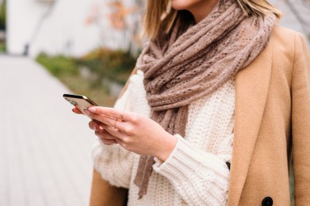 Female holding her phone on an autumn day closeup 3 - free stock photo