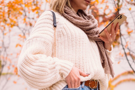 Female holding her phone on an autumn day closeup 3 - free stock photo