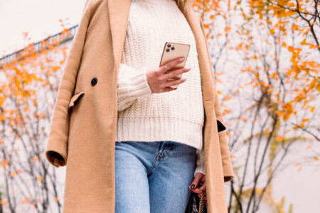 Female holding her phone on an autumn day 4 - free stock photo