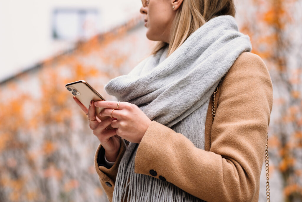 Female holding her phone on an autumn day closeup 5 - free stock photo