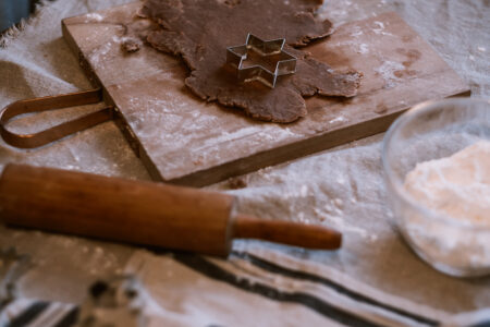 Cutting out gingerbread Christmas biscuits - free stock photo